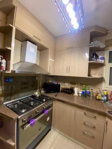 a kitchen with a stove and a counter top at A gorgeous furnished 3 BDs apt in 6th Of October