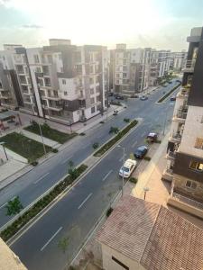 a view of a city street with cars and buildings at A gorgeous furnished 3 BDs apt in 6th Of October