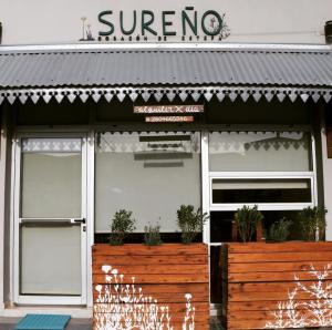 a store with two doors and a sign on it at Sureño in Puerto Pirámides