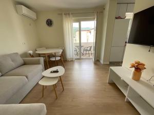 a living room with a couch and a table at Spring apartment in Permet in Përmet