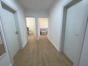 an empty hallway with white walls and wood floors at Spring apartment in Permet in Përmet