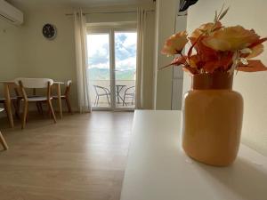 a vase filled with flowers sitting on a table at Spring apartment in Permet in Përmet