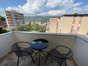 a blue table and two chairs on a balcony at Spring apartment in Permet in Përmet