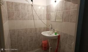a bathroom with a sink and a shower at Граничар 3 СЪРФА in Granichar +78 photos