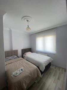 Postel nebo postele na pokoji v ubytování Seyrantepe Apart