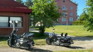 two motorcycles parked next to a brick building at Old School in Suolahti +34 photos