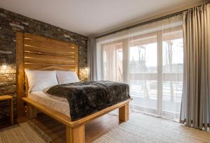 a bedroom with a bed and a large window at Willa Tatiana Boutique in Zakopane