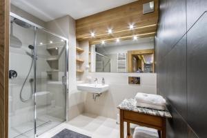 a bathroom with a glass shower and a sink at Willa Tatiana Boutique in Zakopane +24 photos