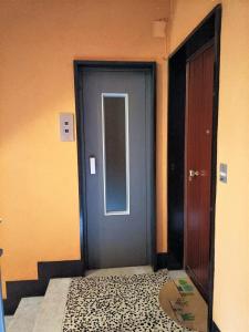 a blue door in a room with a leopardandom floor at FRONTE del GOLF in Rapallo
