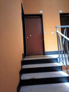 a set of stairs with a red door in a building at FRONTE del GOLF in Rapallo