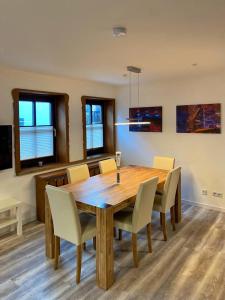 a dining room with a wooden table and chairs at Ferienwohnung Vintage Willingen in Willingen