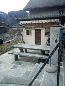 a picnic table in front of a building at Casa Cima in Lavorgo