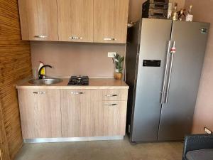 a small kitchen with a sink and a refrigerator at Casa Marisa in Eforie Nord