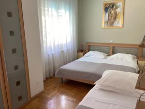 Posteľ alebo postele v izbe v ubytovaní Apartman Brankica