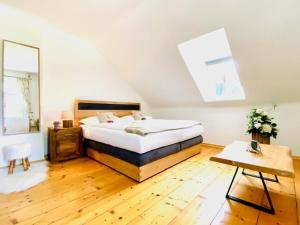 a bedroom with a bed and a wooden floor at Mariazeller Alpen Chalet in Mariazell