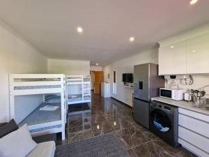 a kitchen with two bunk beds in a room at Stunning Apartment Near Clubs in Albufeira