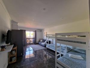 a room with two bunk beds and a living room at Stunning Apartment Near Clubs in Albufeira