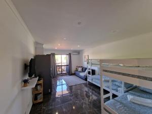 a room with two bunk beds and a couch at Stunning Apartment Near Clubs in Albufeira