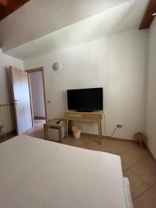 a living room with a flat screen tv and a table at Labiente Suite & Breakfast in Peschici