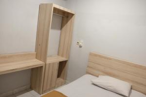 Postel nebo postele na pokoji v ubytování Palm Garden Kuta