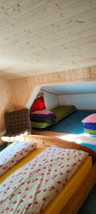 two bunk beds in a room with a wooden ceiling at Panorama Hotel Wagenkehr in Innertkirchen