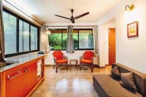 a living room with a couch and a table at The Burrow in South Goa. in Dabolim