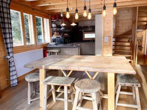 a large wooden table in a kitchen with stools at La Pourvoirie - 4 Vallées - Thyon-Les Collons, 10 personnes, pistes de ski à 200m, vue magnifique ! in Hérémence +42 photos