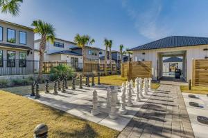 a giant chess set on a lawn in front of a house at Modern Luxury 4BR Pool Bay Access Outdoor Dining in Pensacola