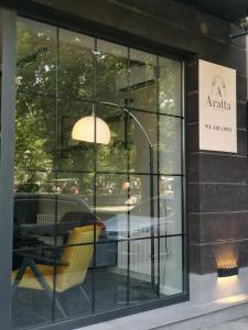 a window of a restaurant with a table and a lamp at Aratta Boutique Hotel in Yerevan