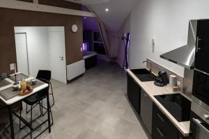 a kitchen with a sink and a counter top at L'incognito - Romantisme - Vin - Jacuzzi in Saumur