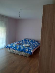 a small bed in a room with a wooden floor at Sunny in Trnava