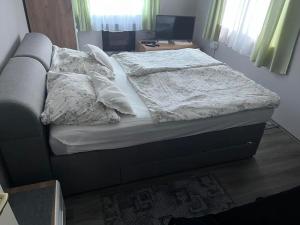 A bed or beds in a room at Talabér Vendégház Még 24 kép