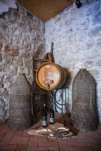 a stone wall with a lamp and two baskets at Boutique Hotel Tomić in Lopud Island