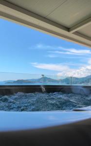 a bath tub with a view of the ocean at Vertmont Villa in Sveti Stefan