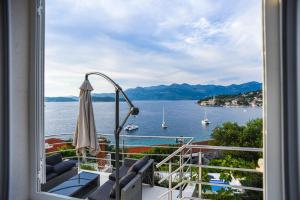 a balcony with a view of the water and boats at Boutique Hotel Tomić in Lopud