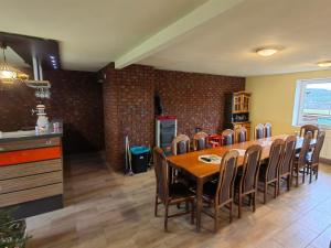 a kitchen and dining room with a table and chairs at Chata Jesenka in Čachrov