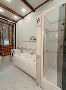 Riverside Old Town Spacious One Bedroom Apartment في ريغا: حمام أبيض مع حوض استحمام ودش