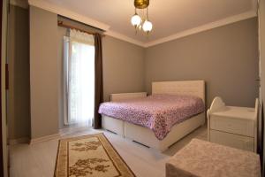 a bedroom with a bed and a window at Yazıcı Villa in Macka