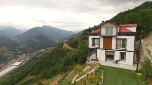 a house on a hill with a view of a valley at Yazıcı Villa in Macka