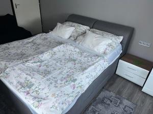 A bed or beds in a room at Talabér Vendégház