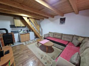 a living room with a couch and a table at Vikendice Bungalovi Menzil in Zavidovići