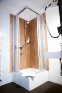 a shower in a bathroom with a glass window at Hotel Rheinpromenade8 in Emmerich