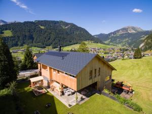 an aerial view of a house in the mountains at Barbara's Ferienwohnungen in Au im Bregenzerwald