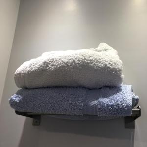 a pile of towels sitting on top of a shelf at BLUE AND WHITE PAINTERS HOUSE in Athens