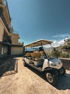 a golf cart parked in front of a house at Vertmont Villa in Sveti Stefan
