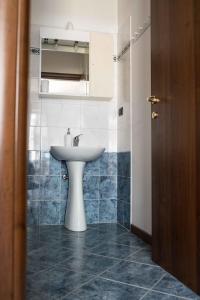 a bathroom with a white sink and blue tiles at "Le Charmant" - CIR VDA-SAINT-VINCENT-n 0004 in Saint Vincent