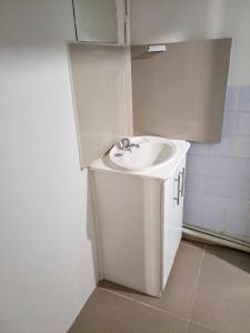 a bathroom with a white sink in a room at Town Centre Stays in Nadi