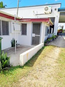 a white house with a yard in front of it at Town Centre Stays in Nadi