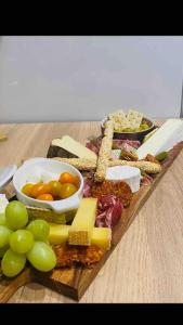 a plate of food with cheese and grapes on a table at L’oasis spa in Quiévrechain