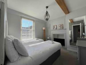 a white bedroom with a large bed and a window at Old Town Retreat, Grade Ii Listed, Margate Kent in Kent